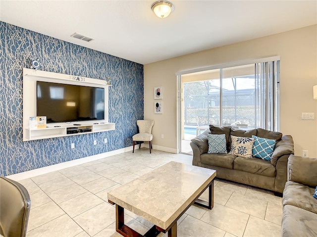 5303 Wildwood Way, Davenport, FL 33837 - living room featuring wallpapered walls, an accent wall, and tile patterned flooring