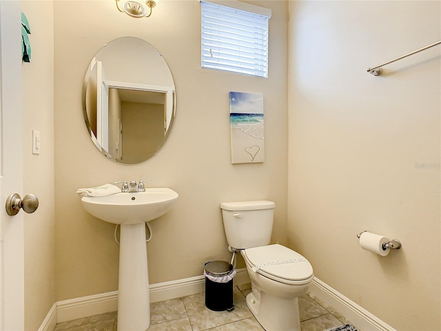 bathroom featuring tile patterned flooring, toilet, and sink