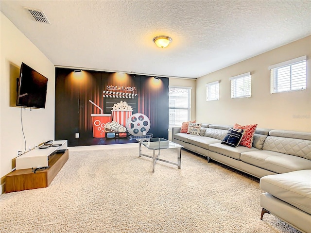 carpeted living room featuring a textured ceiling