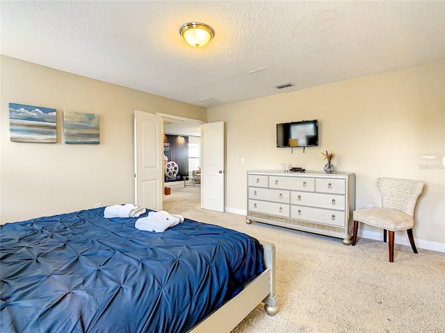 bedroom with carpet flooring and a textured ceiling