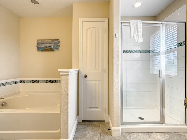 bathroom featuring shower with separate bathtub