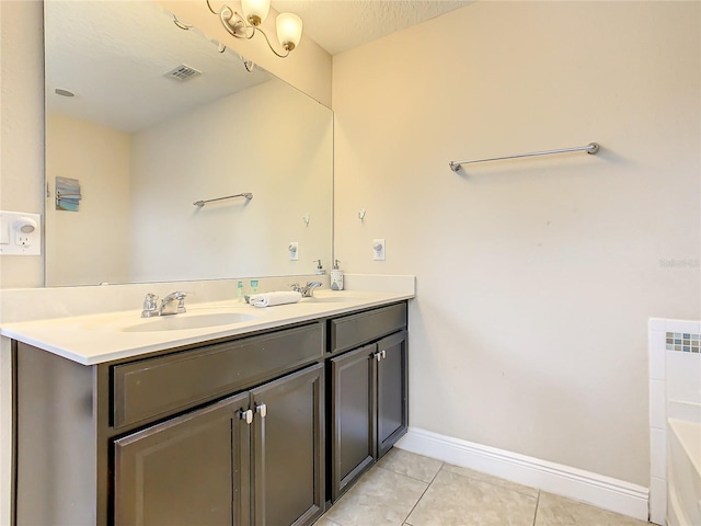 bathroom featuring tile patterned floors, vanity, and a textured ceiling