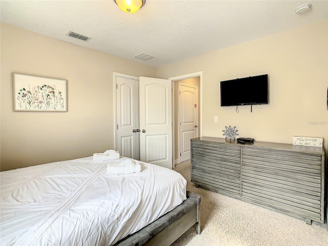 carpeted bedroom with a closet