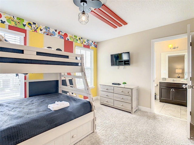 carpeted bedroom featuring ensuite bath