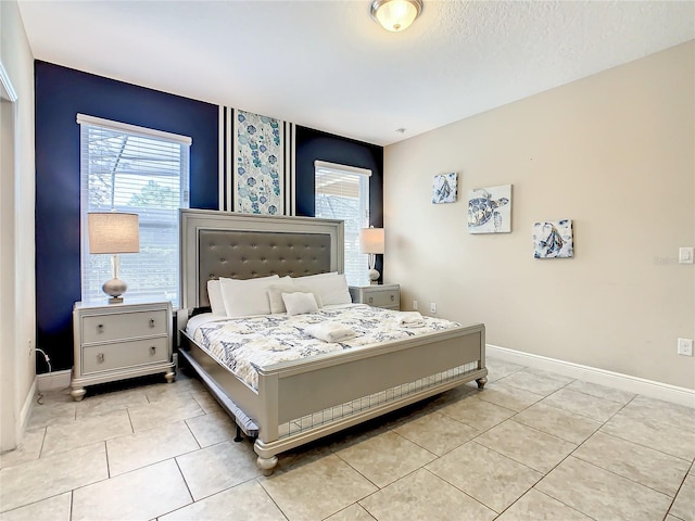 tiled bedroom featuring a textured ceiling