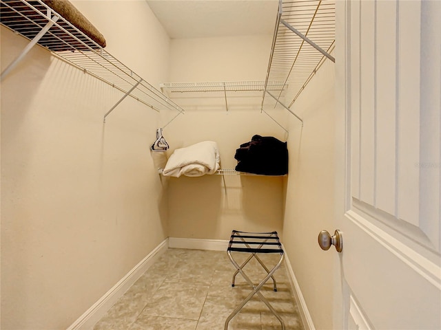 spacious closet featuring light tile patterned floors