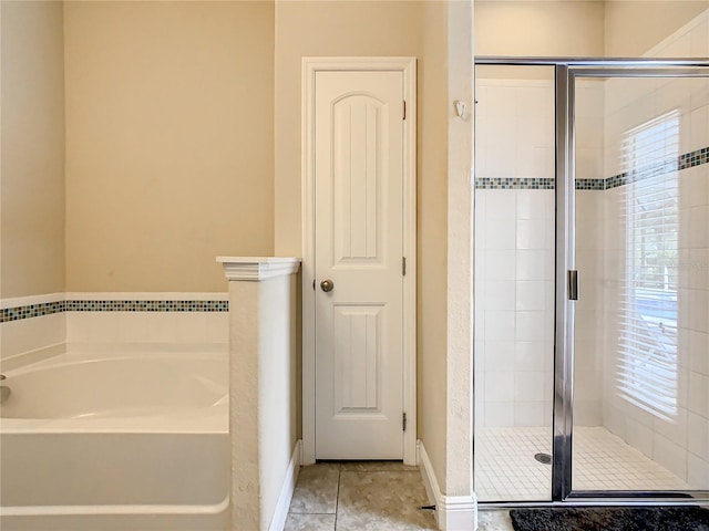 bathroom with separate shower and tub and tile patterned flooring