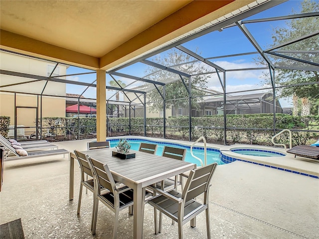 view of patio / terrace with a lanai and a pool with hot tub