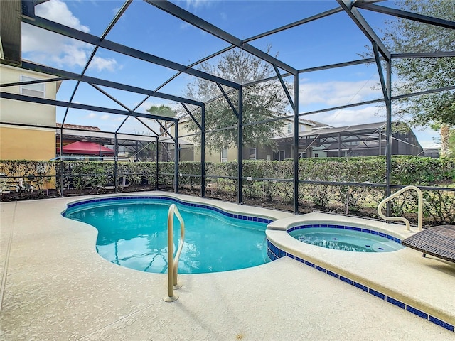 view of pool featuring an in ground hot tub, a patio, and a lanai