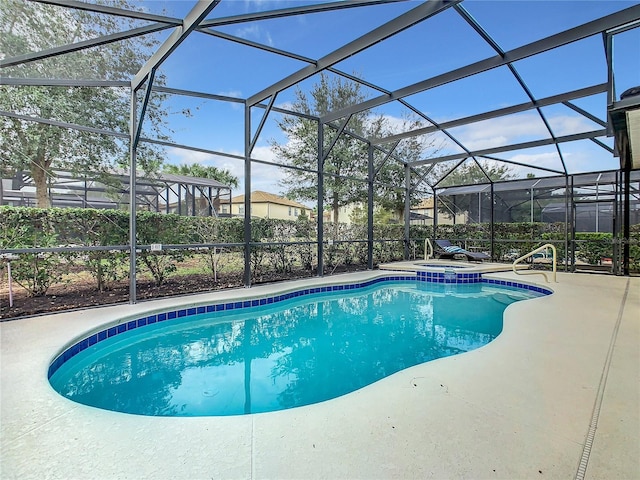 view of swimming pool with a lanai and a patio area