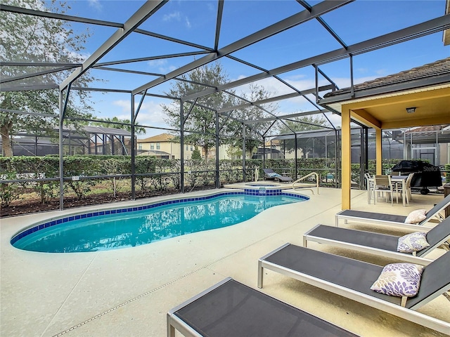 view of swimming pool featuring an in ground hot tub, a patio, and glass enclosure