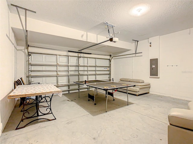 5303 Wildwood Way, Davenport, FL 33837 - playroom with electric panel, a garage, unfinished concrete floors, and a textured ceiling