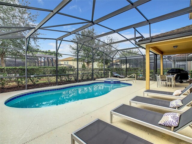 5303 Wildwood Way, Davenport, FL 33837 - view of swimming pool with a patio area, a pool with connected hot tub, and glass enclosure