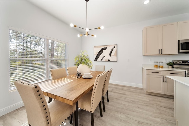 dining area featuring a notable chandelier and light hardwood / wood-style flooring