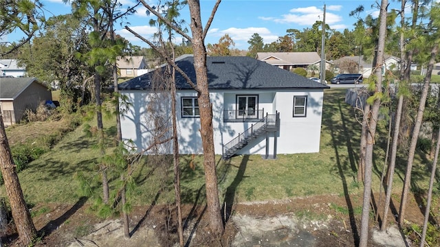 rear view of house featuring a yard