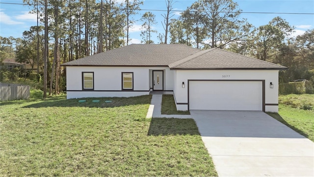 view of front of property featuring a front yard and a garage