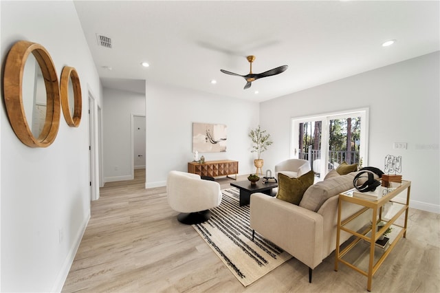 living room with ceiling fan and light hardwood / wood-style floors