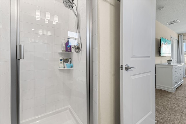 bathroom with a textured ceiling and walk in shower