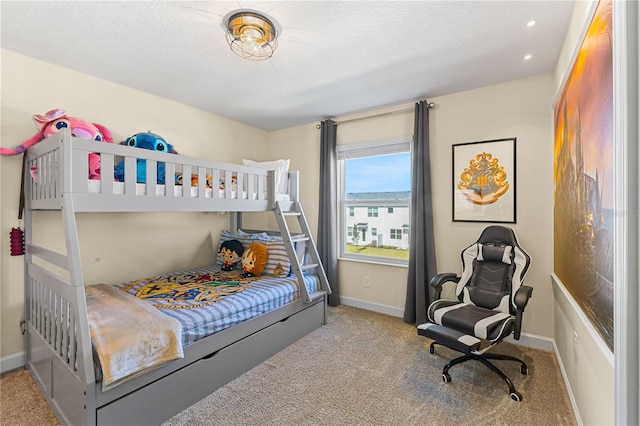 carpeted bedroom with a textured ceiling