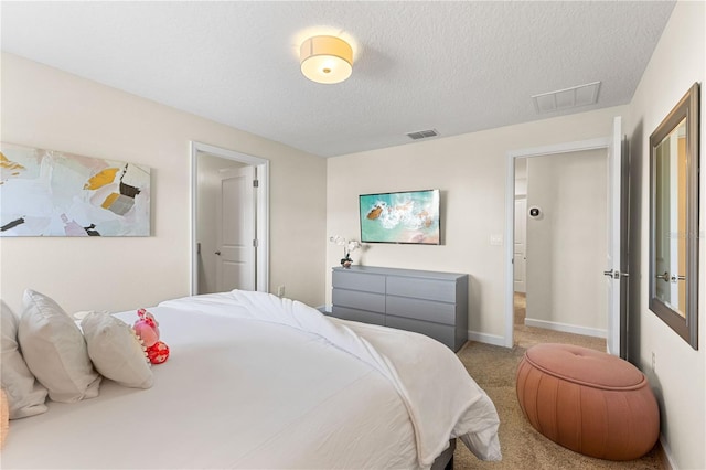 bedroom featuring carpet and a textured ceiling