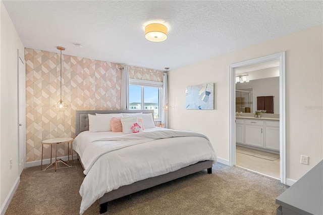 bedroom featuring carpet, ensuite bathroom, tile walls, and a textured ceiling