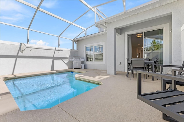 view of swimming pool with a lanai, a patio, and grilling area