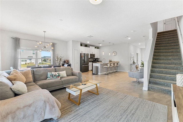 living room featuring sink and a chandelier