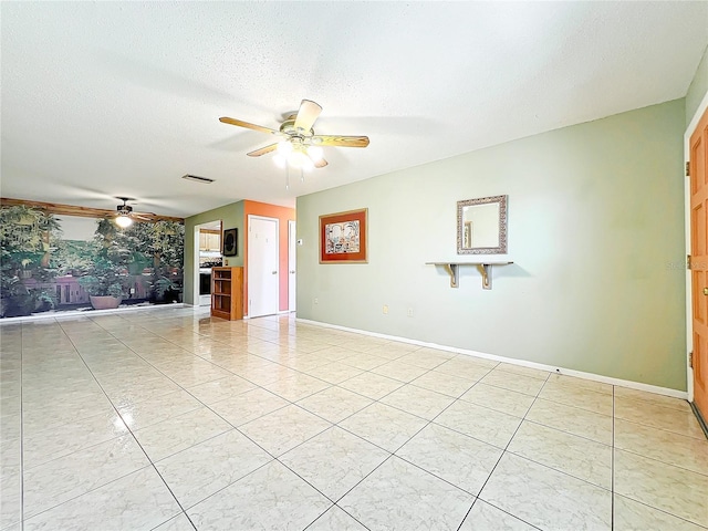 unfurnished living room with light tile patterned floors, a textured ceiling, and ceiling fan