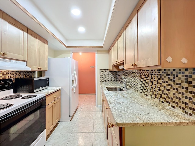 kitchen with sink, a raised ceiling, light stone counters, extractor fan, and white appliances