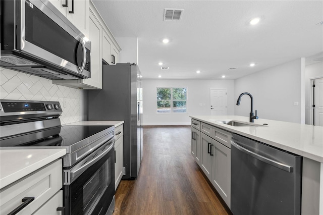 kitchen featuring backsplash, dark hardwood / wood-style floors, sink, and stainless steel appliances