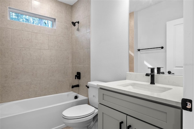 full bathroom featuring toilet, vanity, and tiled shower / bath