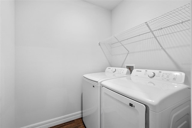 laundry room featuring washing machine and dryer and dark wood-type flooring