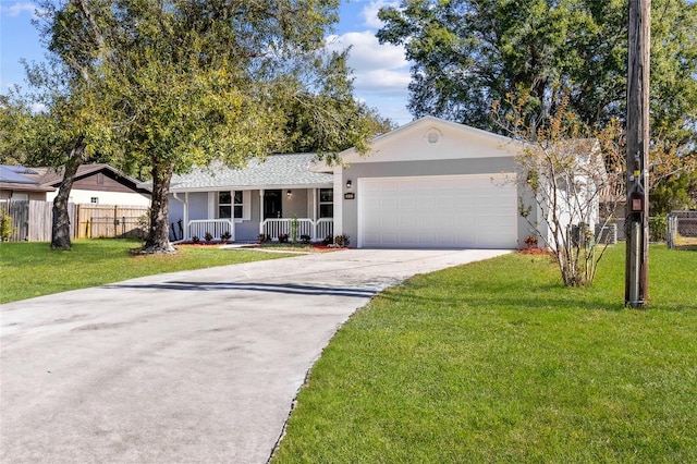 single story home with covered porch, a garage, and a front lawn