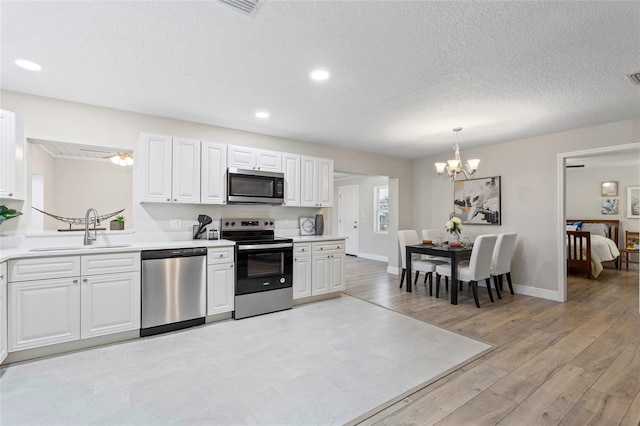 kitchen featuring white cabinets, light hardwood / wood-style floors, sink, and stainless steel appliances