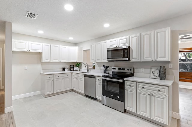 kitchen featuring white cabinetry, sink, and stainless steel appliances