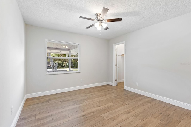 empty room featuring ceiling fan, a textured ceiling, and light hardwood / wood-style flooring