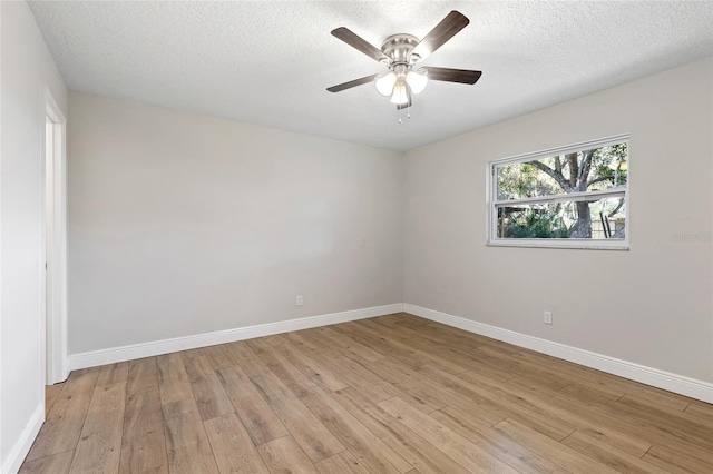 spare room with a textured ceiling, light hardwood / wood-style flooring, and ceiling fan