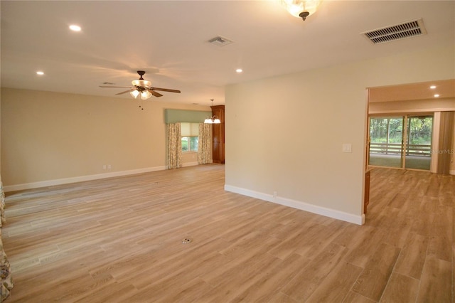 unfurnished room with light wood-type flooring and ceiling fan