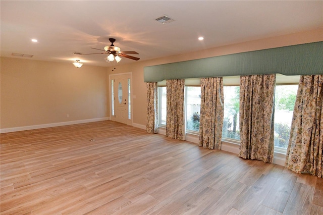 spare room featuring light wood-type flooring and ceiling fan