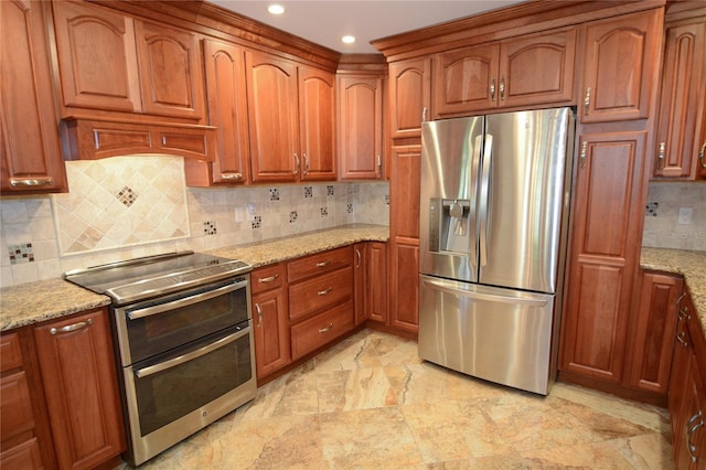 kitchen with decorative backsplash, appliances with stainless steel finishes, and light stone counters