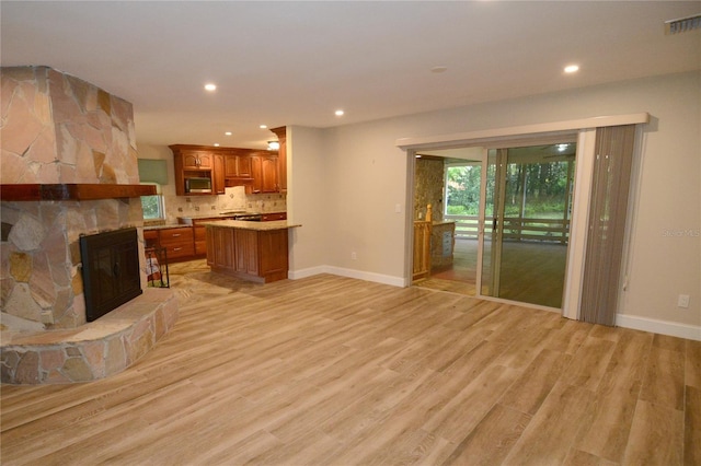 living room featuring a fireplace and light hardwood / wood-style flooring