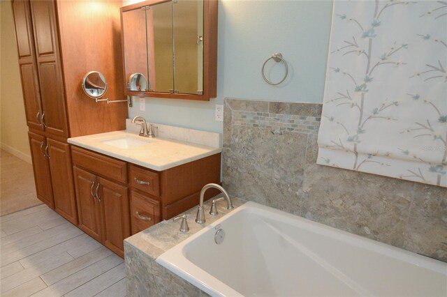 bathroom featuring vanity and a tub to relax in