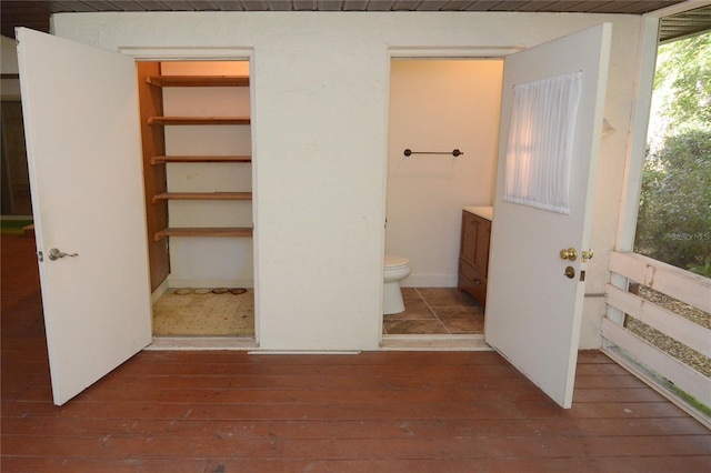 interior space featuring toilet, vanity, and hardwood / wood-style flooring