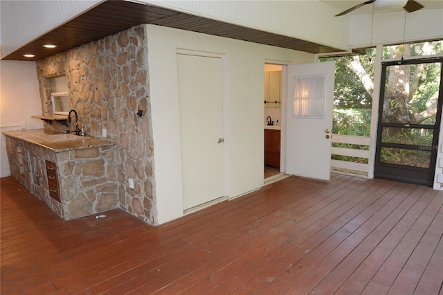 interior space with ceiling fan, wood-type flooring, and sink