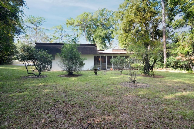 exterior space featuring a lawn and a sunroom