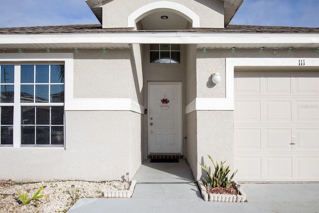 doorway to property featuring a garage