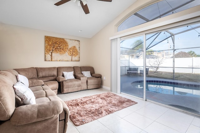 living room with tile patterned flooring, a healthy amount of sunlight, and lofted ceiling