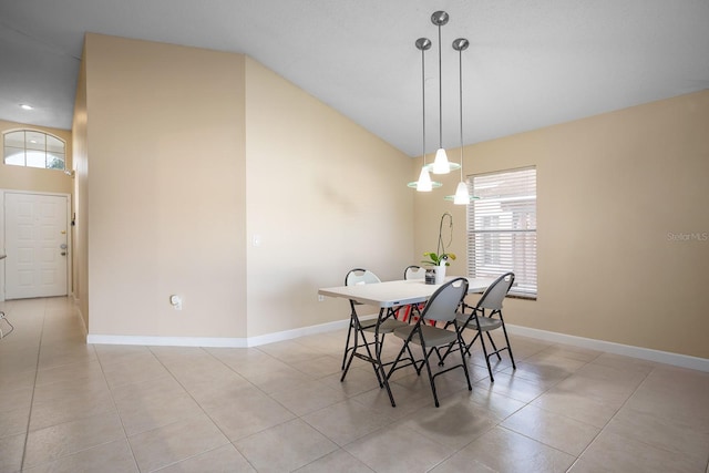 tiled dining space with lofted ceiling