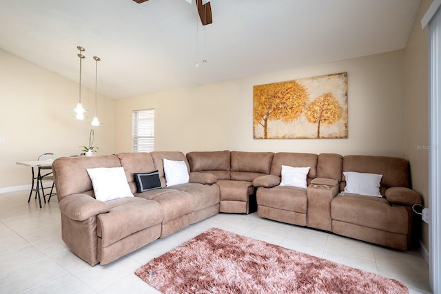 tiled living room featuring ceiling fan and vaulted ceiling