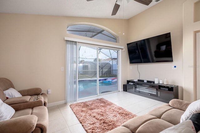 living room featuring ceiling fan, light tile patterned floors, and high vaulted ceiling